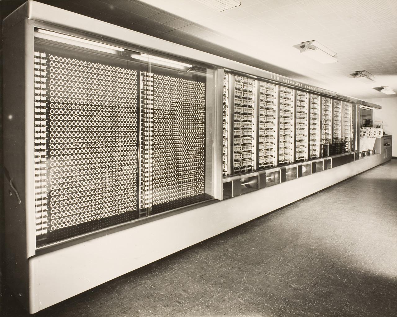 The Harvard Mark I electromechanical computer, its long bank of relays and rotating shafts exposed.